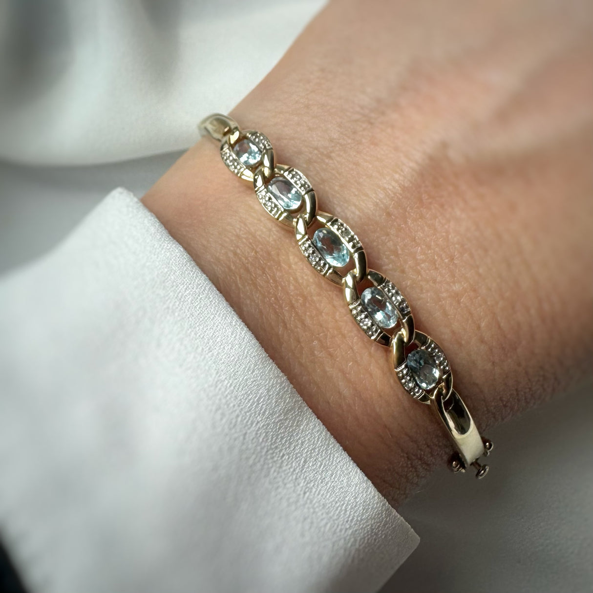 Pre Owned 9ct Yellow Gold Hinged Bangle with Blue Topaz & Diamonds