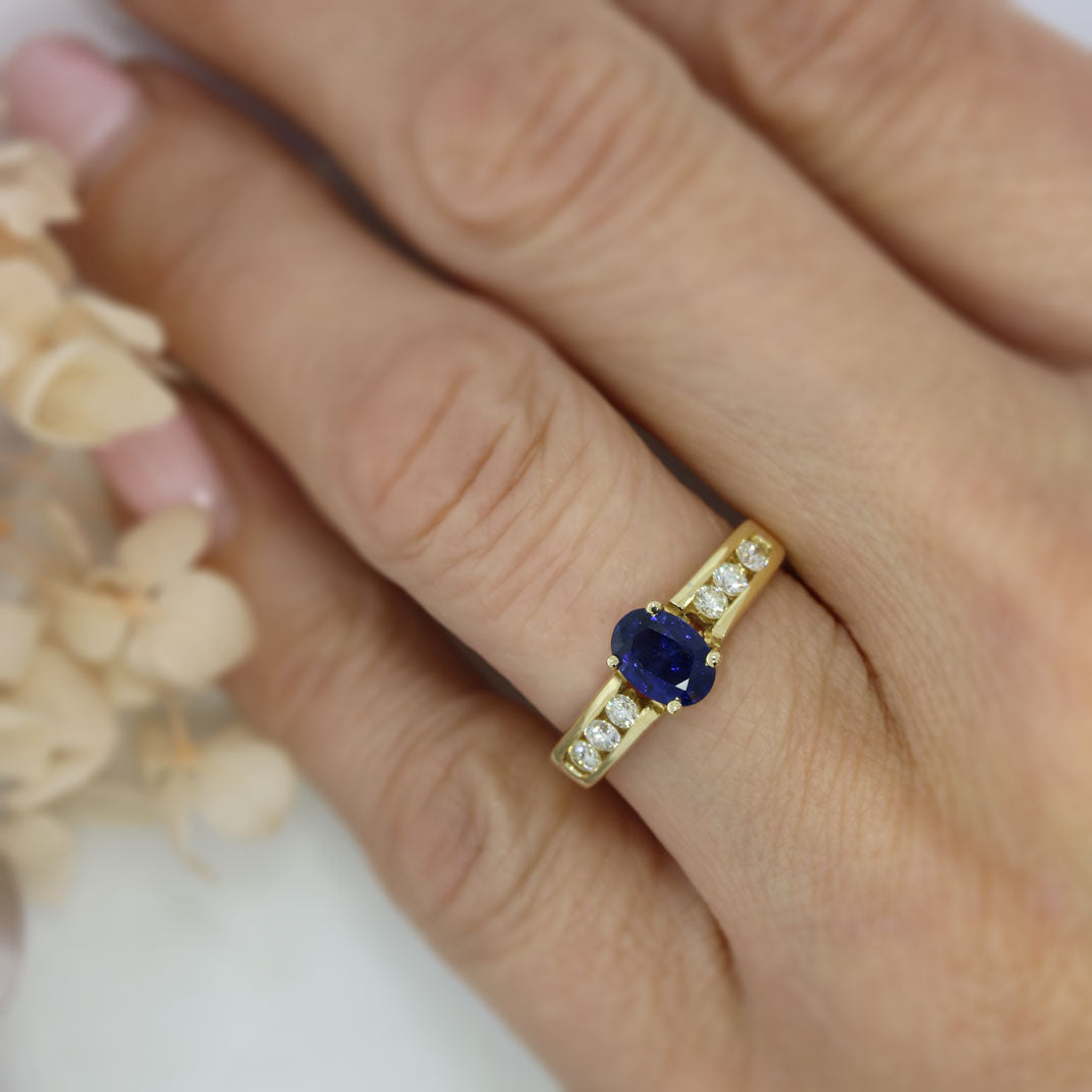 18ct Gold Oval Sapphire Ring with Channel Set Diamond Shoulders