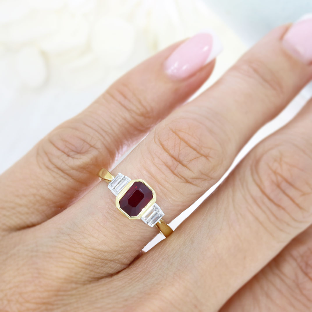 18ct Yellow Gold Rub Over Set Emerald Cut Ruby and 4 Baguette Diamond Ring