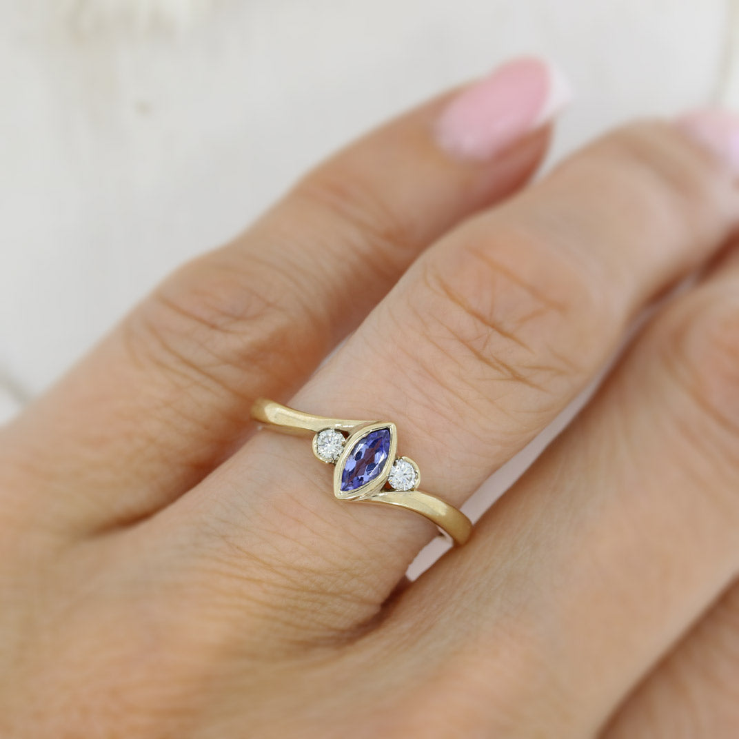 9ct yellow gold tanzanite ring with a diamond either side diamond 0.13ct