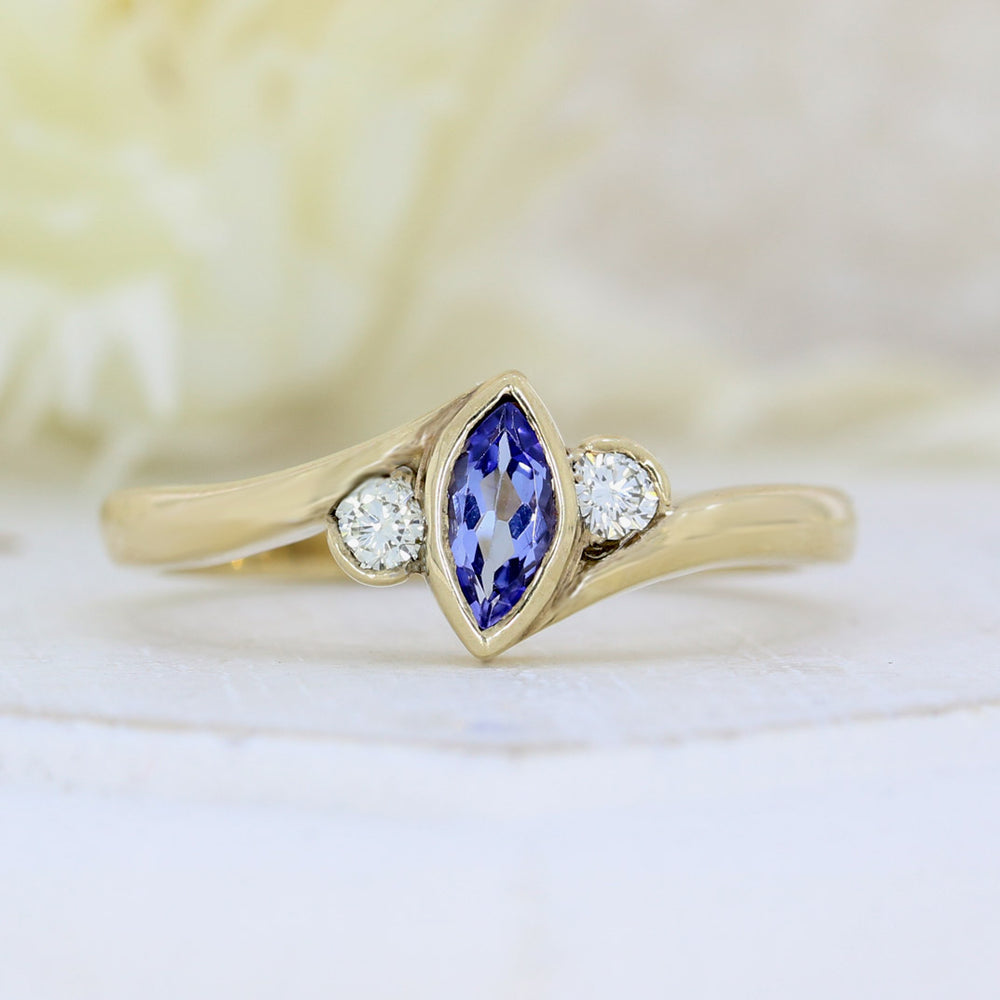 9ct yellow gold tanzanite ring with a diamond either side diamond 0.13ct