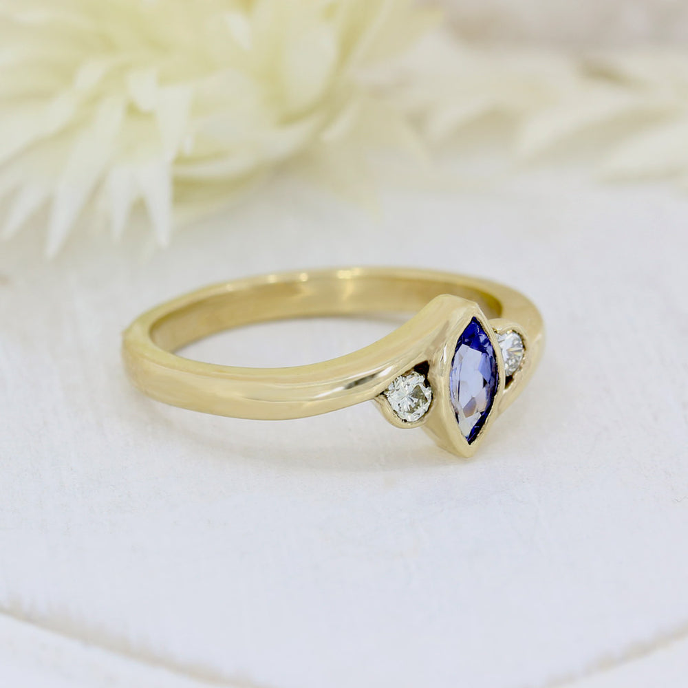 9ct yellow gold tanzanite ring with a diamond either side diamond 0.13ct