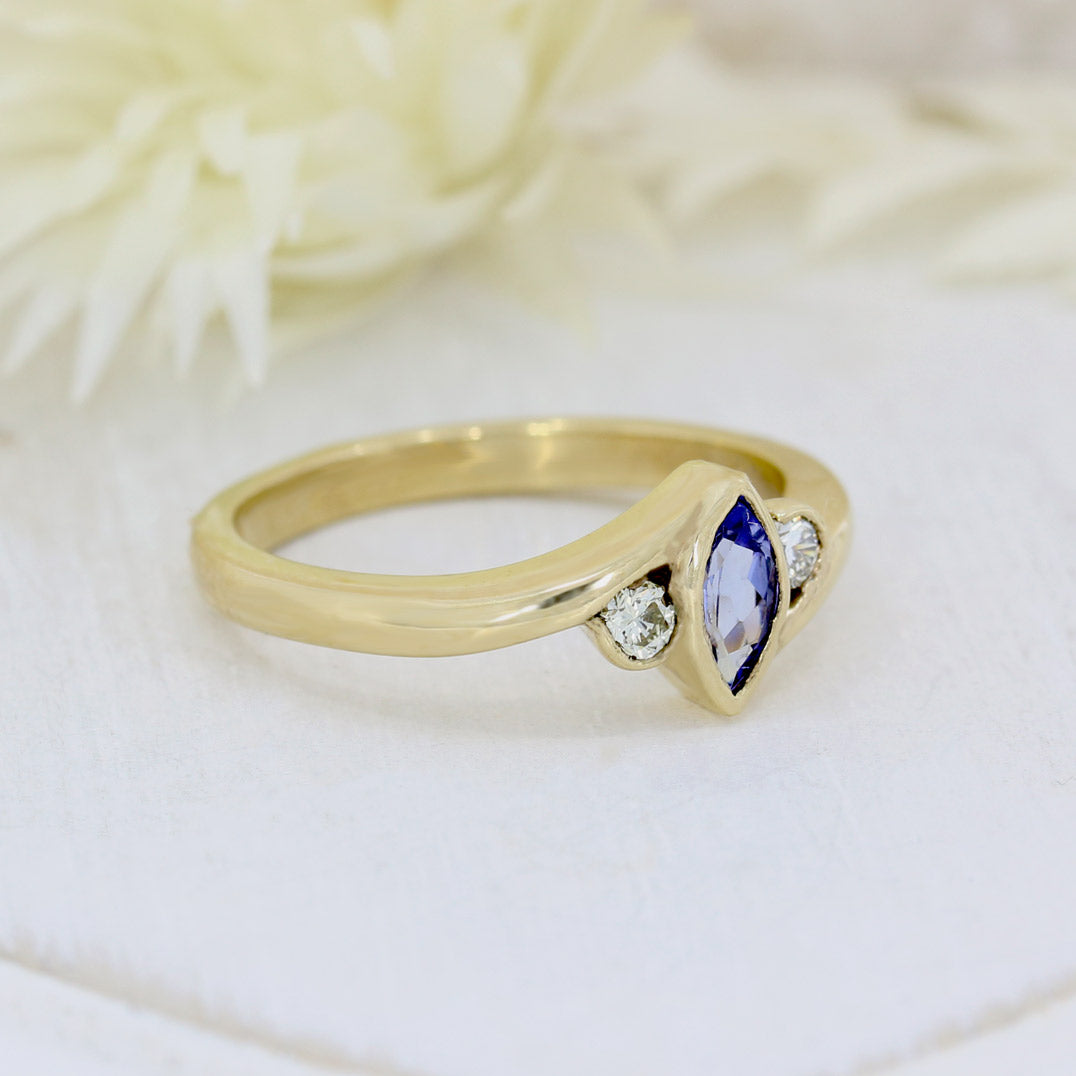 9ct yellow gold tanzanite ring with a diamond either side diamond 0.13ct