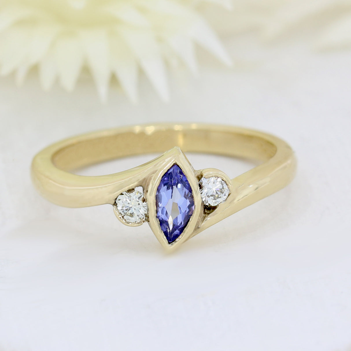 9ct yellow gold tanzanite ring with a diamond either side diamond 0.13ct
