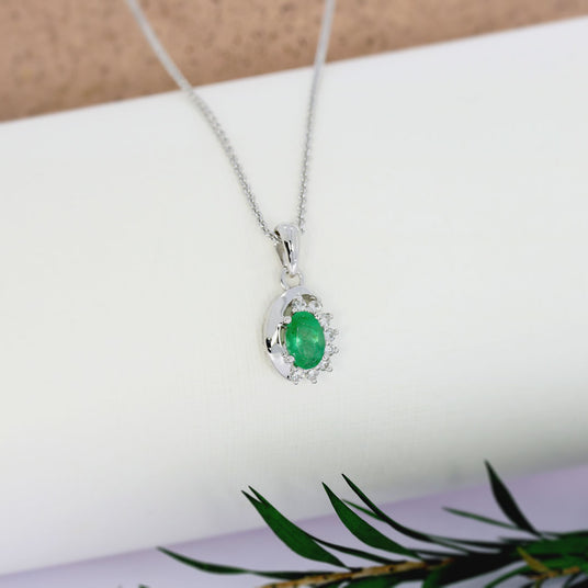 9ct White Gold Oval Emerald Pendant With Claw Set Diamonds To One Side
