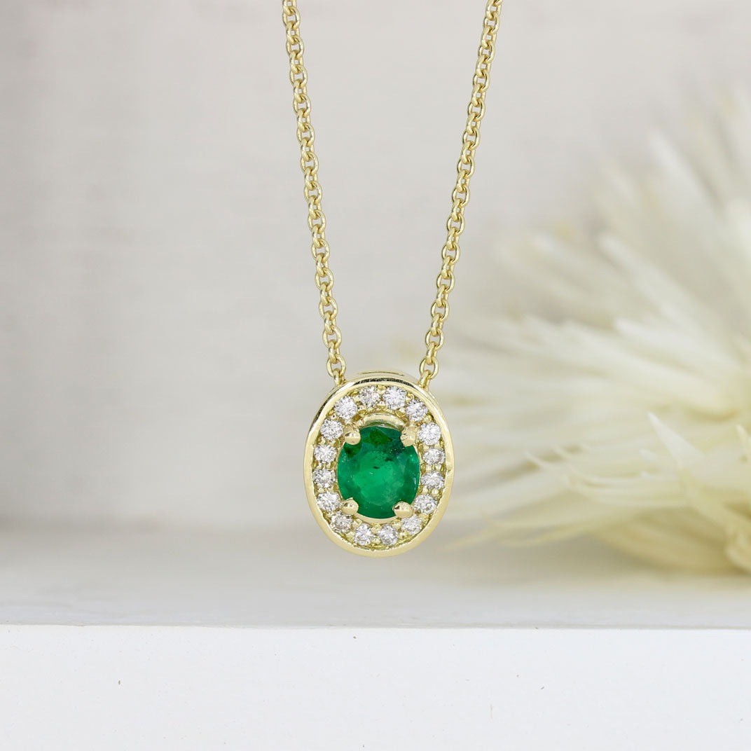 18ct Gold Oval Emerald & Diamond Halo Pendant on a 9ct Yellow Gold Chain