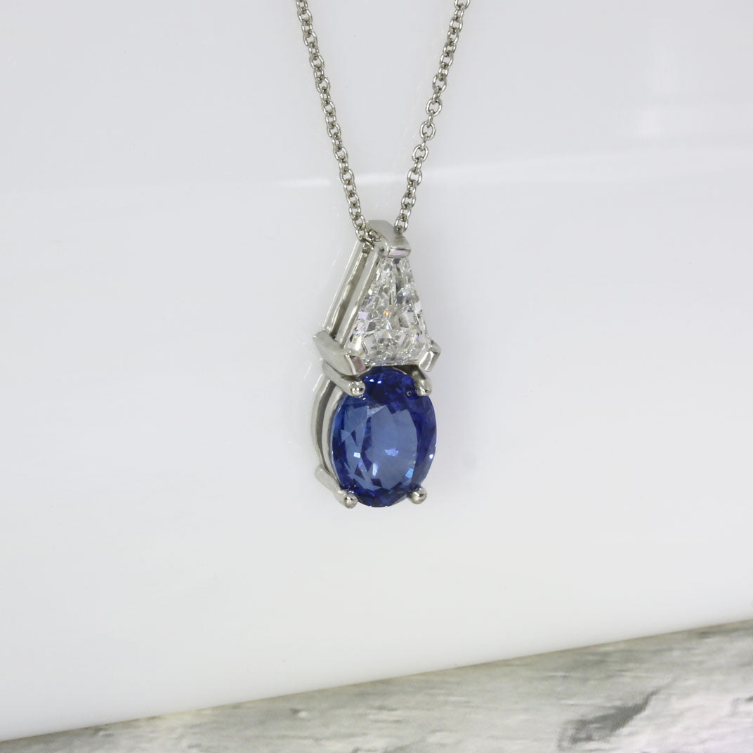 Platinum Oval Sapphire and Trillion Cut Diamond Pendant & Platinum Cha