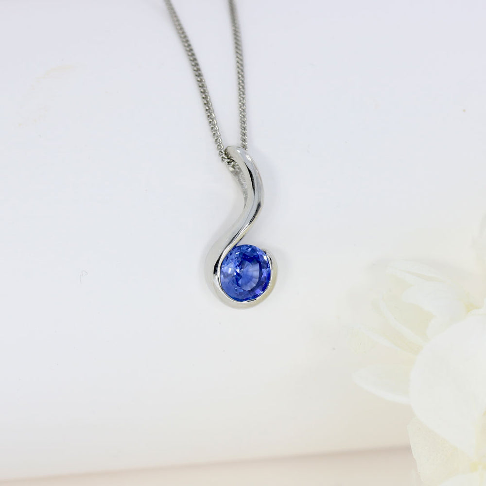 Platinum Rubover Set Round Sapphire Hook Shape Pendant on Platinum 18" Chain