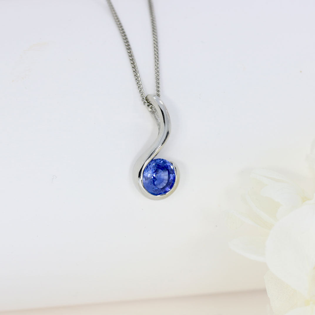 Platinum Rubover Set Round Sapphire Hook Shape Pendant on Platinum 18" Chain