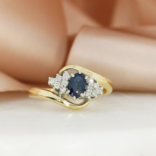 Pre Owned 9ct Yellow Gold Oval Sapphire & Diamond Cluster Ring in a Crossover Setting