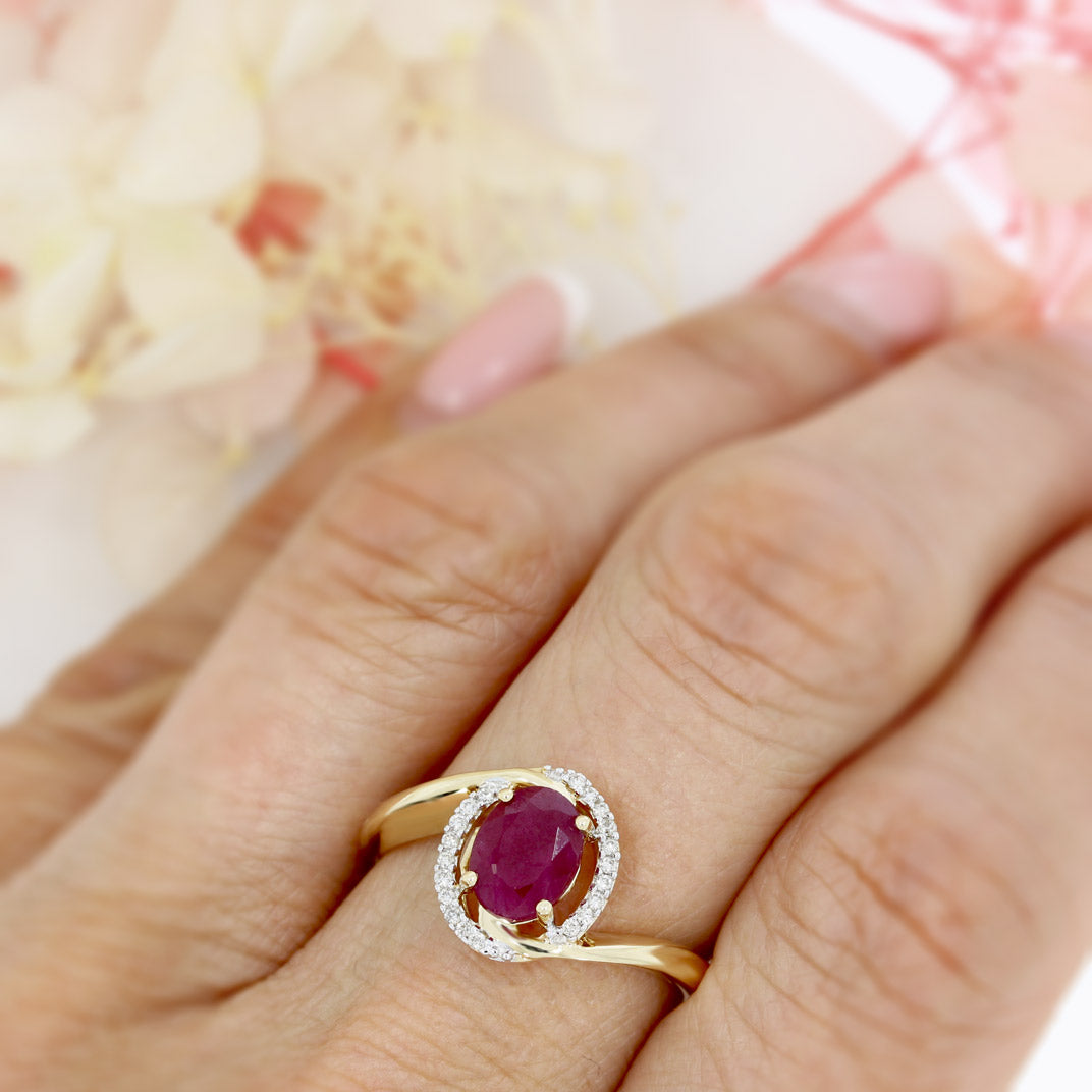 Pre Owned 14ct Gold Oval Ruby Twist Ring with Diamond Halo