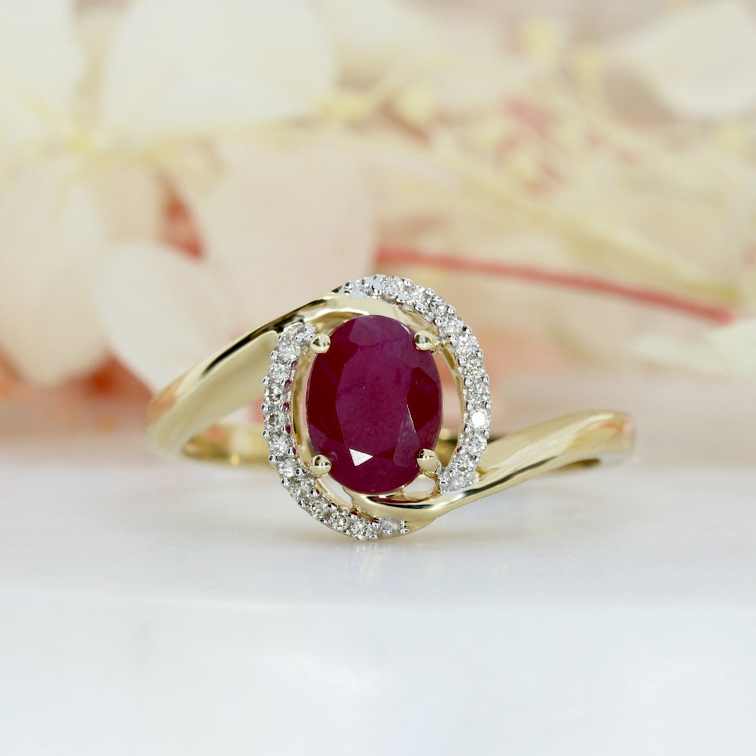 Pre Owned 14ct Gold Oval Ruby Twist Ring with Diamond Halo