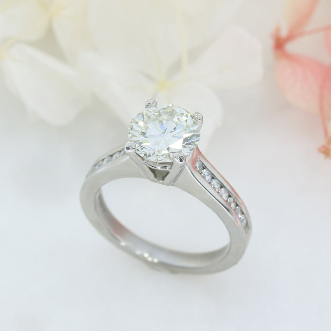 Pre Owned Platinum Natural Diamond Solitaire Ring with Channel Set Shoulders
