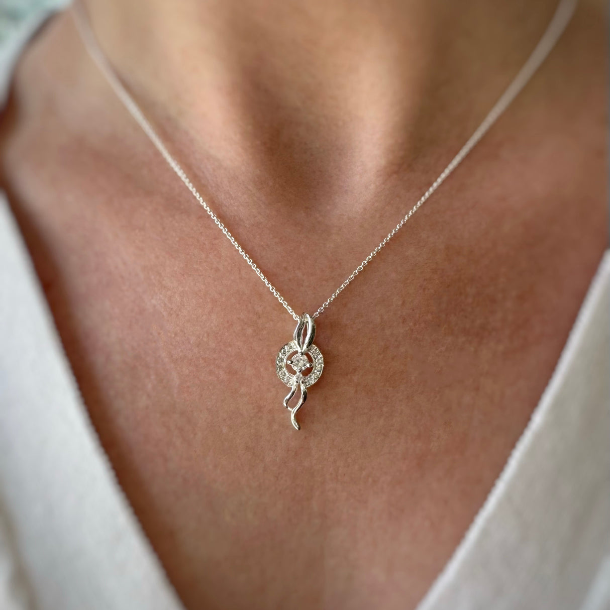 Silver Cubic Zirconia Pave Set Circle with Silver Ribbons