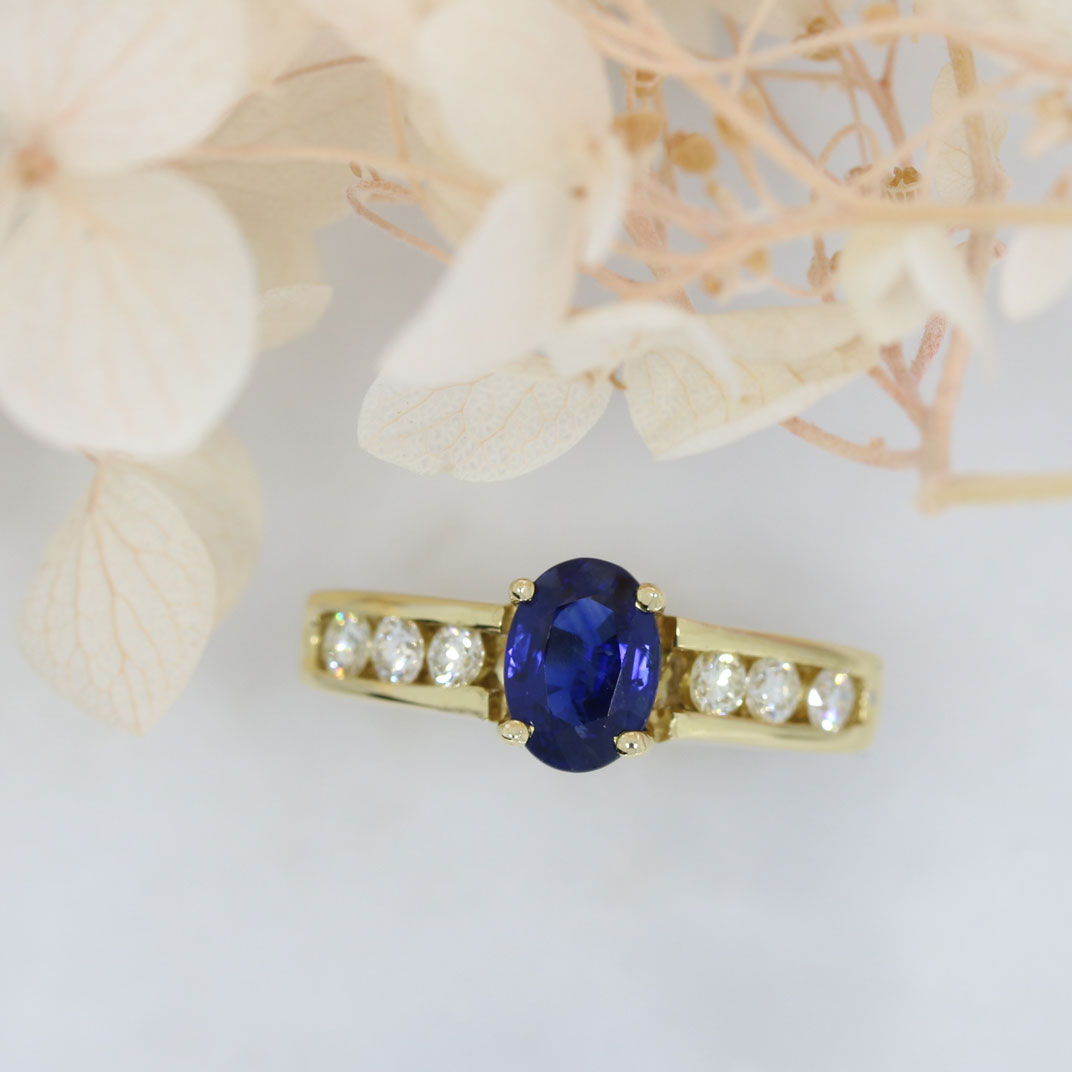 18ct Gold Oval Sapphire Ring with Channel Set Diamond Shoulders