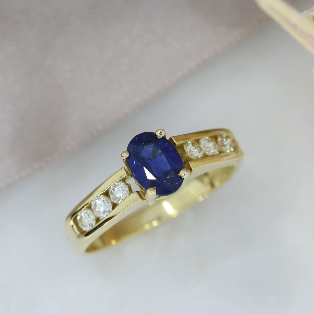 18ct Gold Oval Sapphire Ring with Channel Set Diamond Shoulders