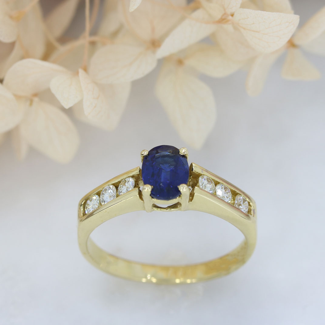 18ct Gold Oval Sapphire Ring with Channel Set Diamond Shoulders