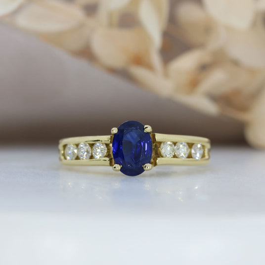 18ct Gold Oval Sapphire Ring with Channel Set Diamond Shoulders