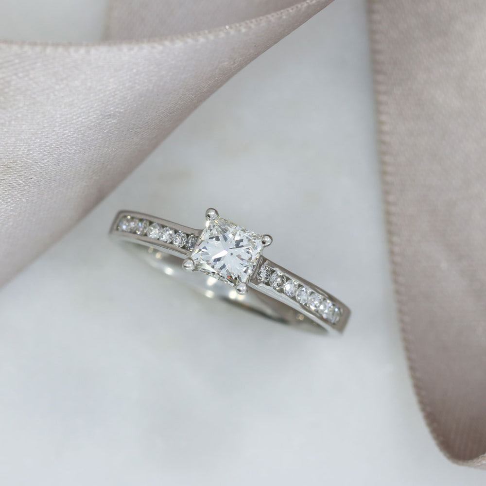 Pre Owned Platinum Princess Cut Solitaire with Channel Set Shoulders 0.75ct