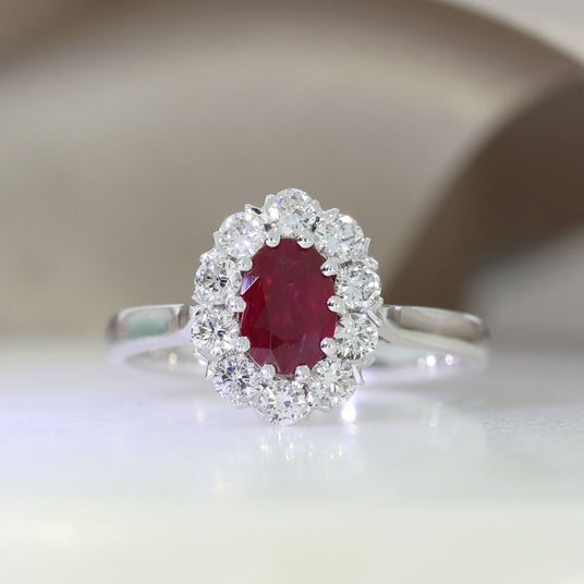 18ct White Gold Claw Set Oval Ruby and Diamond Halo Ring