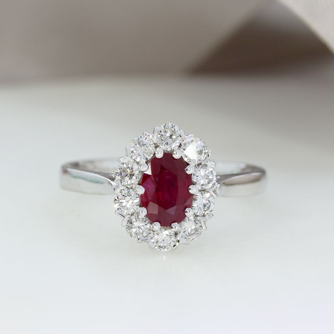 18ct White Gold Claw Set Oval Ruby and Diamond Halo Ring