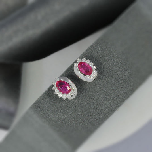 9ct White Gold Oval Ruby Earrings With Claw Set Diamonds