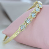 Pre Owned 9ct Yellow Gold Hinged Bangle with Blue Topaz & Diamonds