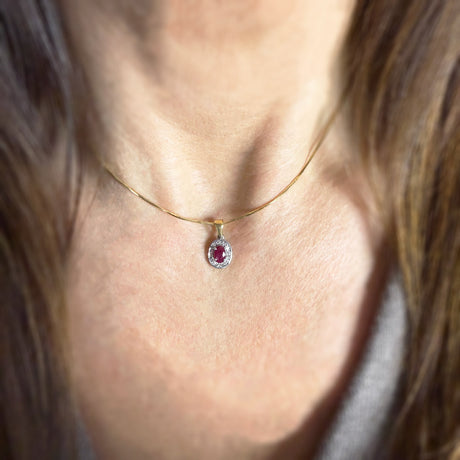 18ct White & Yellow Gold Oval Ruby and Diamond Halo Pendant on an 18ct Chain