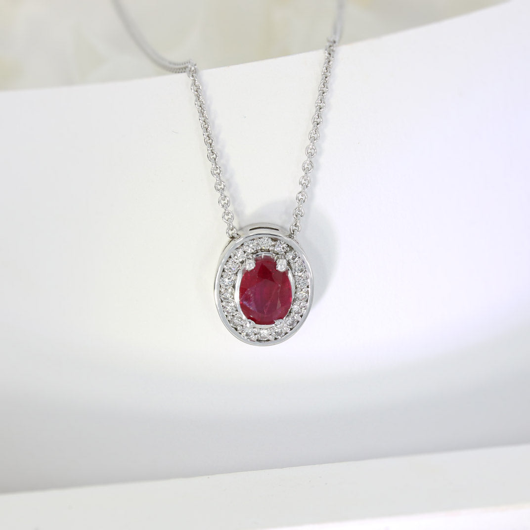 18ct White Gold Oval Ruby and Diamond Halo Pendant on an 18ct 18" Anchor Chain