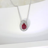 18ct White Gold Oval Ruby and Diamond Halo Pendant on an 18ct 18" Anchor Chain