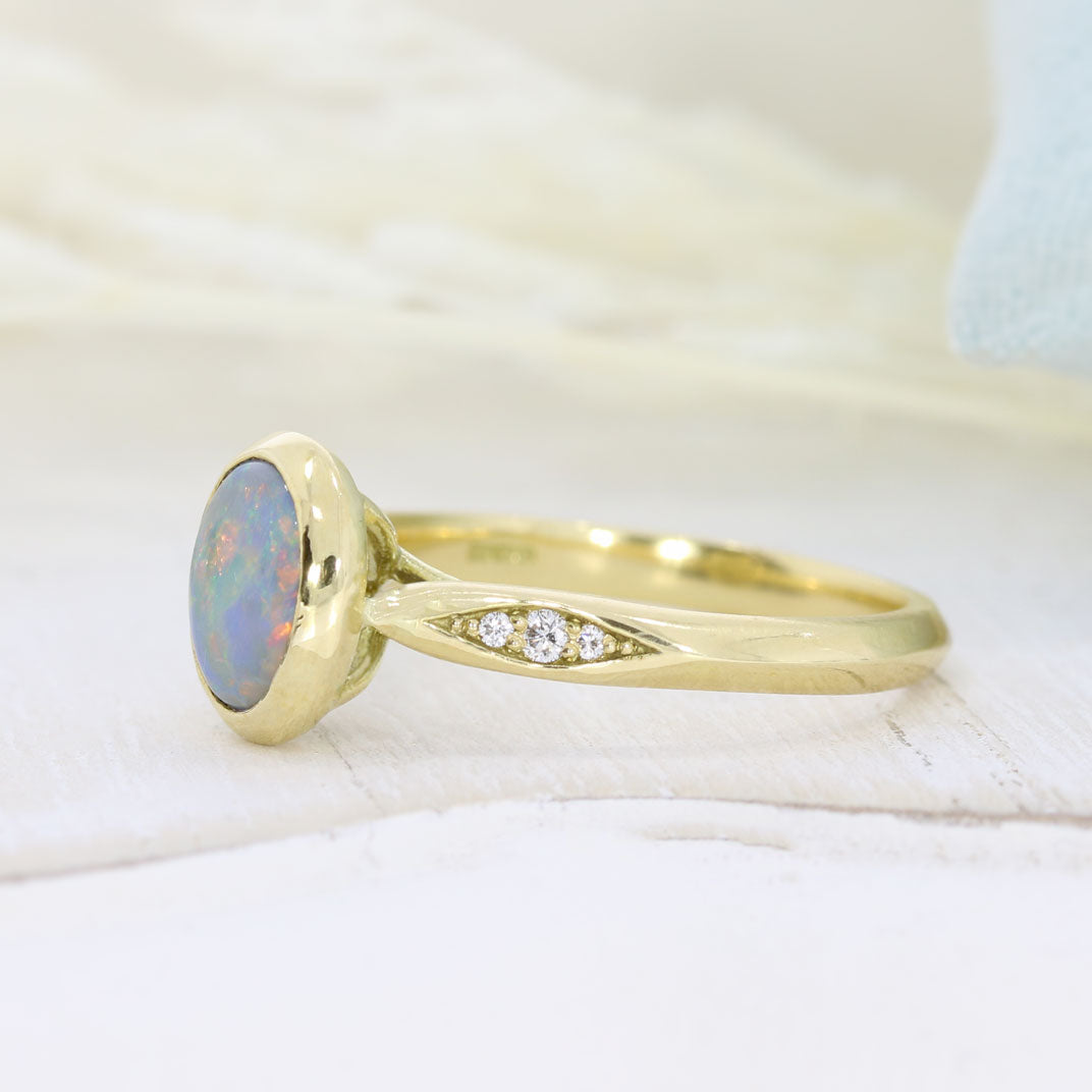 18ct Yellow Gold Oval Rubover Set Opal Dress Ring with Pave Set Diamond Shoulders