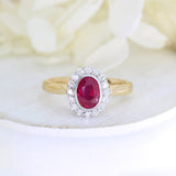 18ct Rose gold rub over set oval ruby and claw set diamond cluster ring