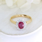 18ct Rose gold rub over set oval ruby and claw set diamond cluster ring