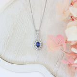 18ct White Gold Sapphire and Diamond Oval Cluster Pendant On a 18ct 18" Chain
