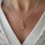 Silver ribbon swirl pendant with single round Cubic Zirconia