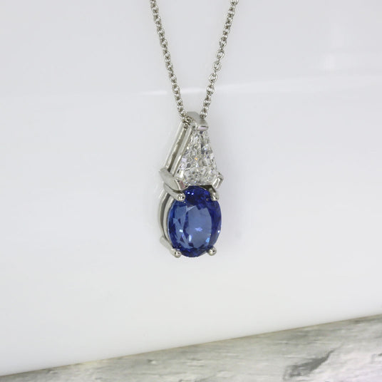 Platinum Oval Sapphire and Trillion Cut Diamond Pendant & Platinum Chain