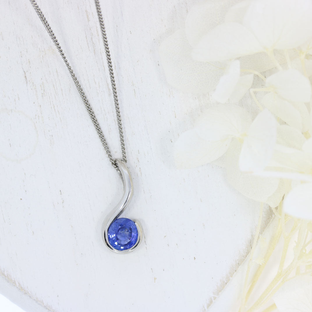 Platinum Rubover Set Round Sapphire Hook Shape Pendant on Platinum 18" Chain