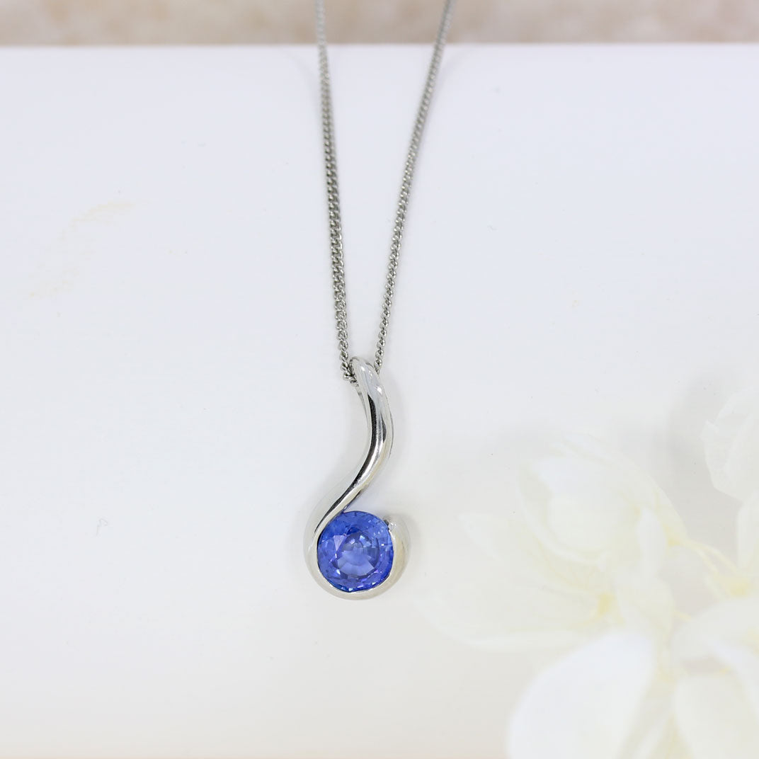 Platinum Rubover Set Round Sapphire Hook Shape Pendant on Platinum 18" Chain