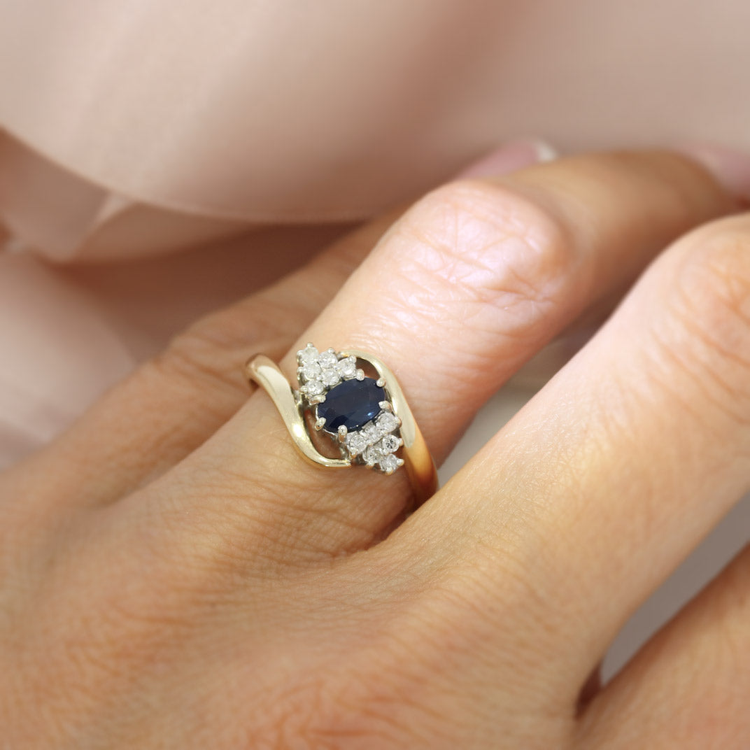 Pre Owned 9ct Yellow Gold Oval Sapphire & Diamond Cluster Ring in a Crossover Setting