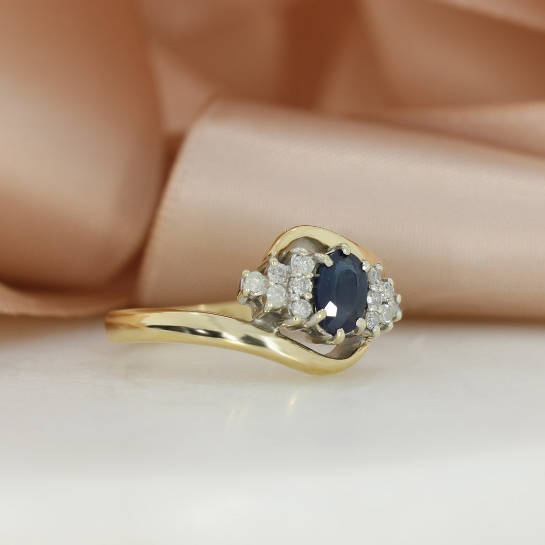 Pre Owned 9ct Yellow Gold Oval Sapphire & Diamond Cluster Ring in a Crossover Setting
