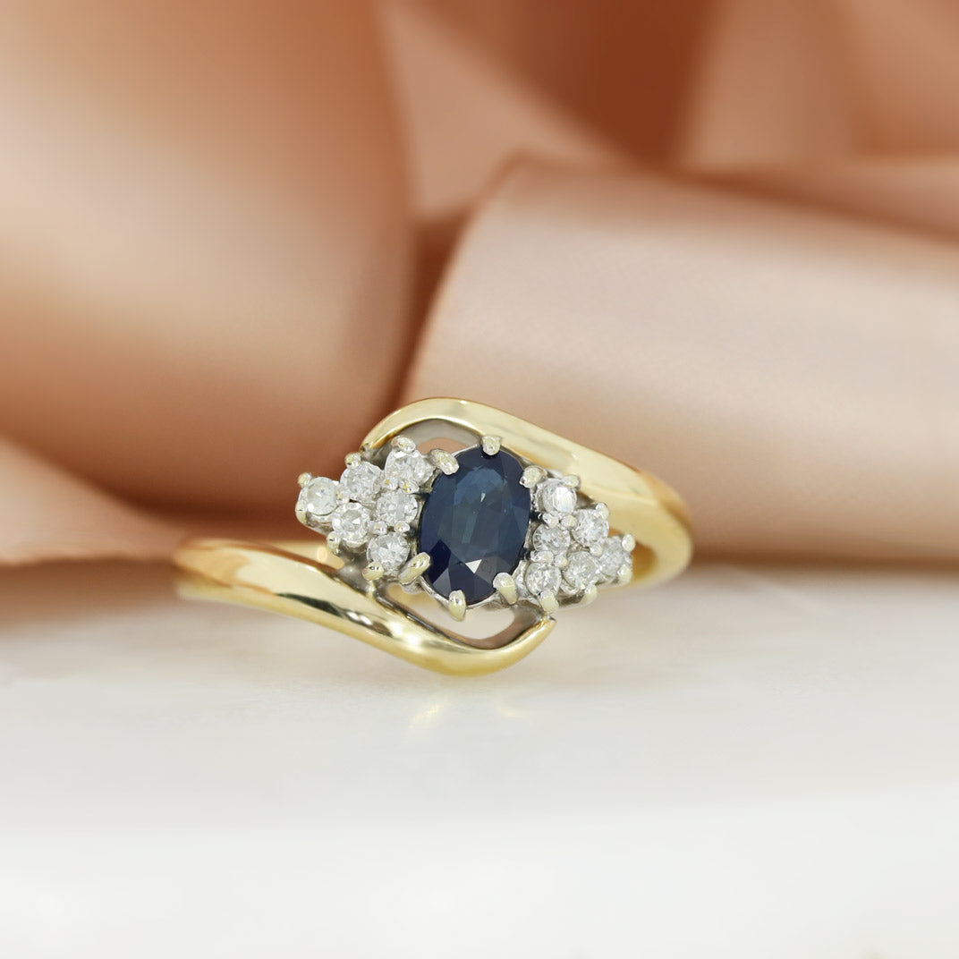 Pre Owned 9ct Yellow Gold Oval Sapphire & Diamond Cluster Ring in a Crossover Setting