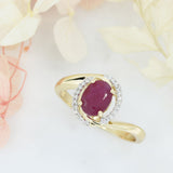 Pre Owned 14ct Gold Oval Ruby Twist Ring with Diamond Halo