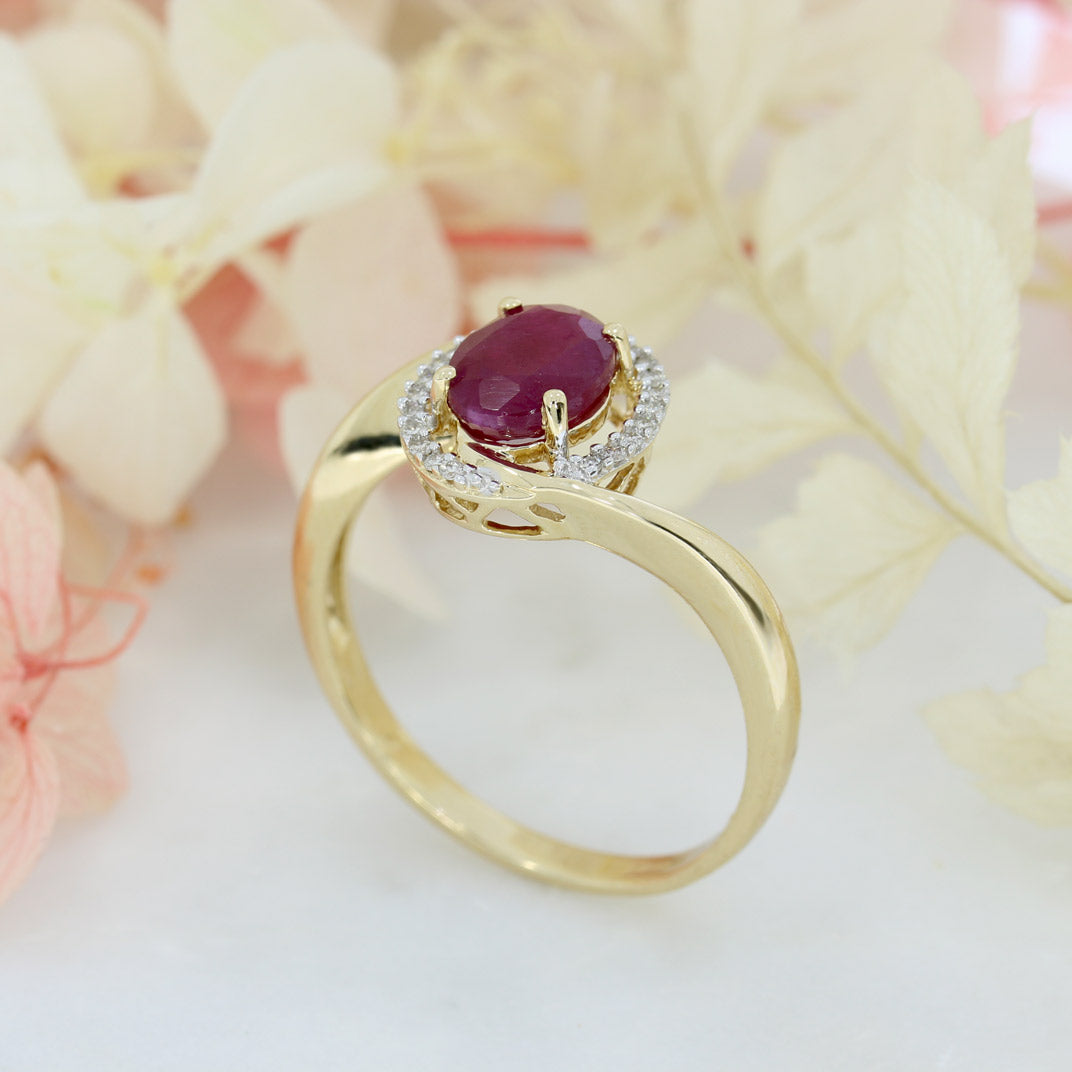 Pre Owned 14ct Gold Oval Ruby Twist Ring with Diamond Halo