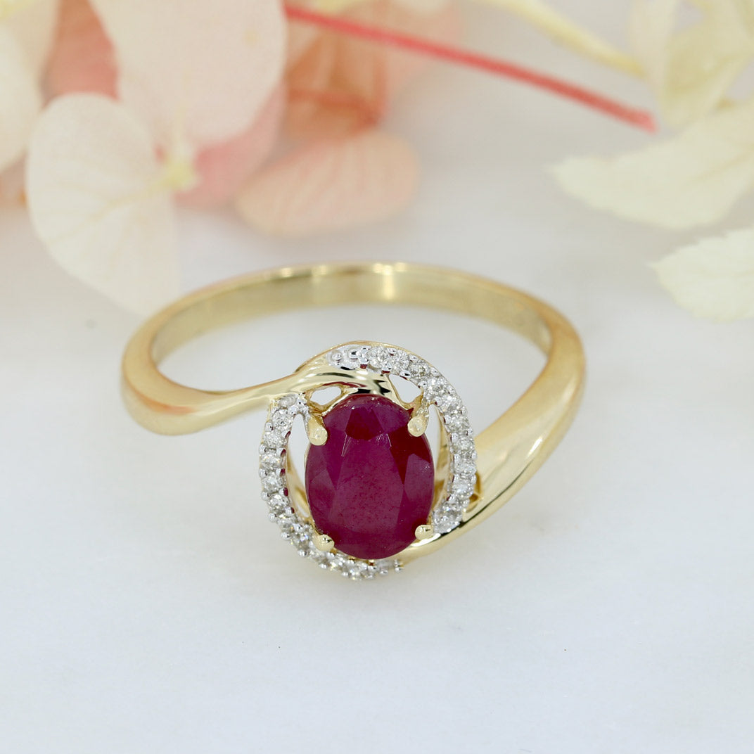 Pre Owned 14ct Gold Oval Ruby Twist Ring with Diamond Halo