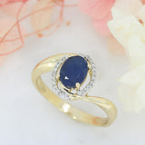 Pre Owned 14ct Gold Oval Sapphire Twist Ring with Diamond Halo
