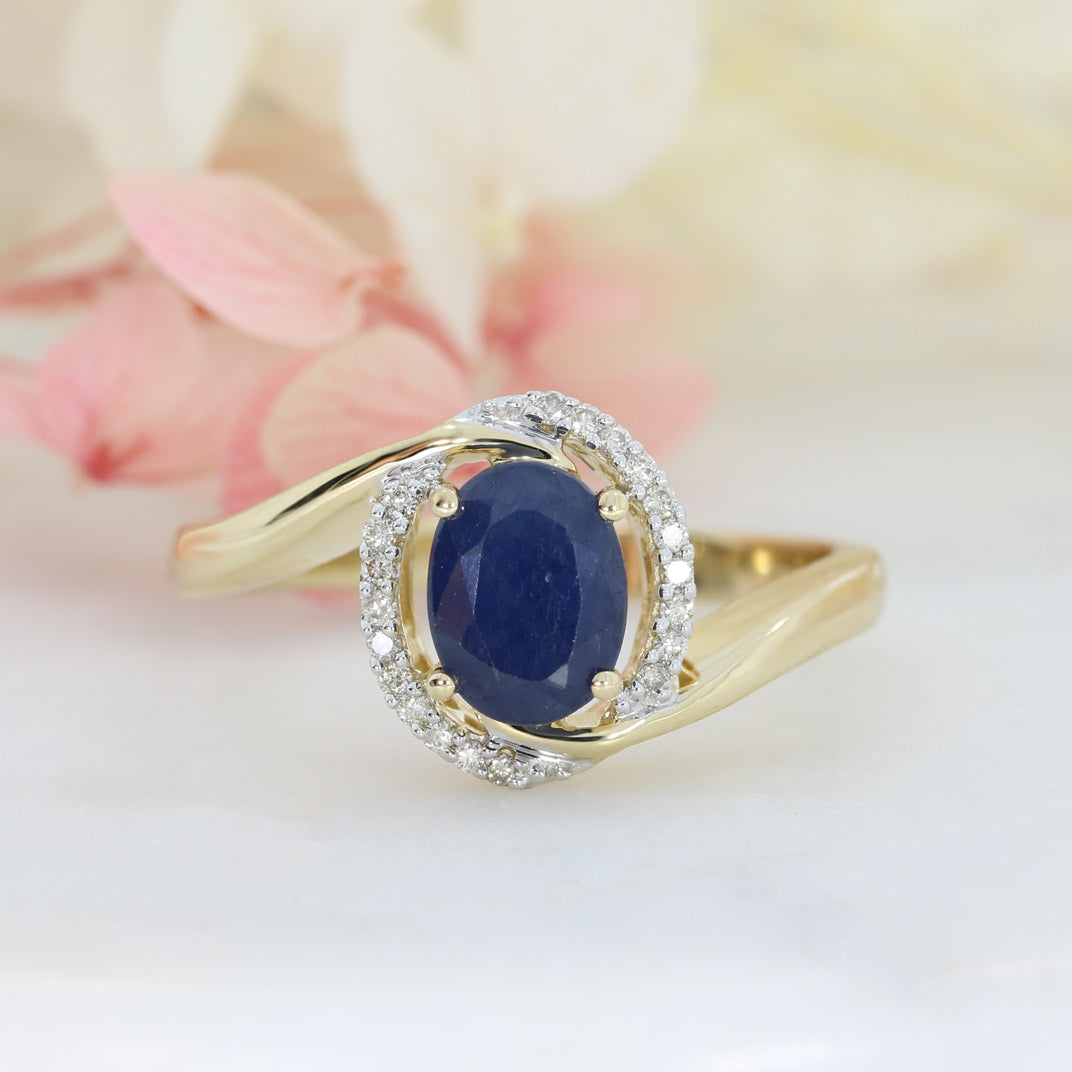 Pre Owned 14ct Gold Oval Sapphire Twist Ring with Diamond Halo