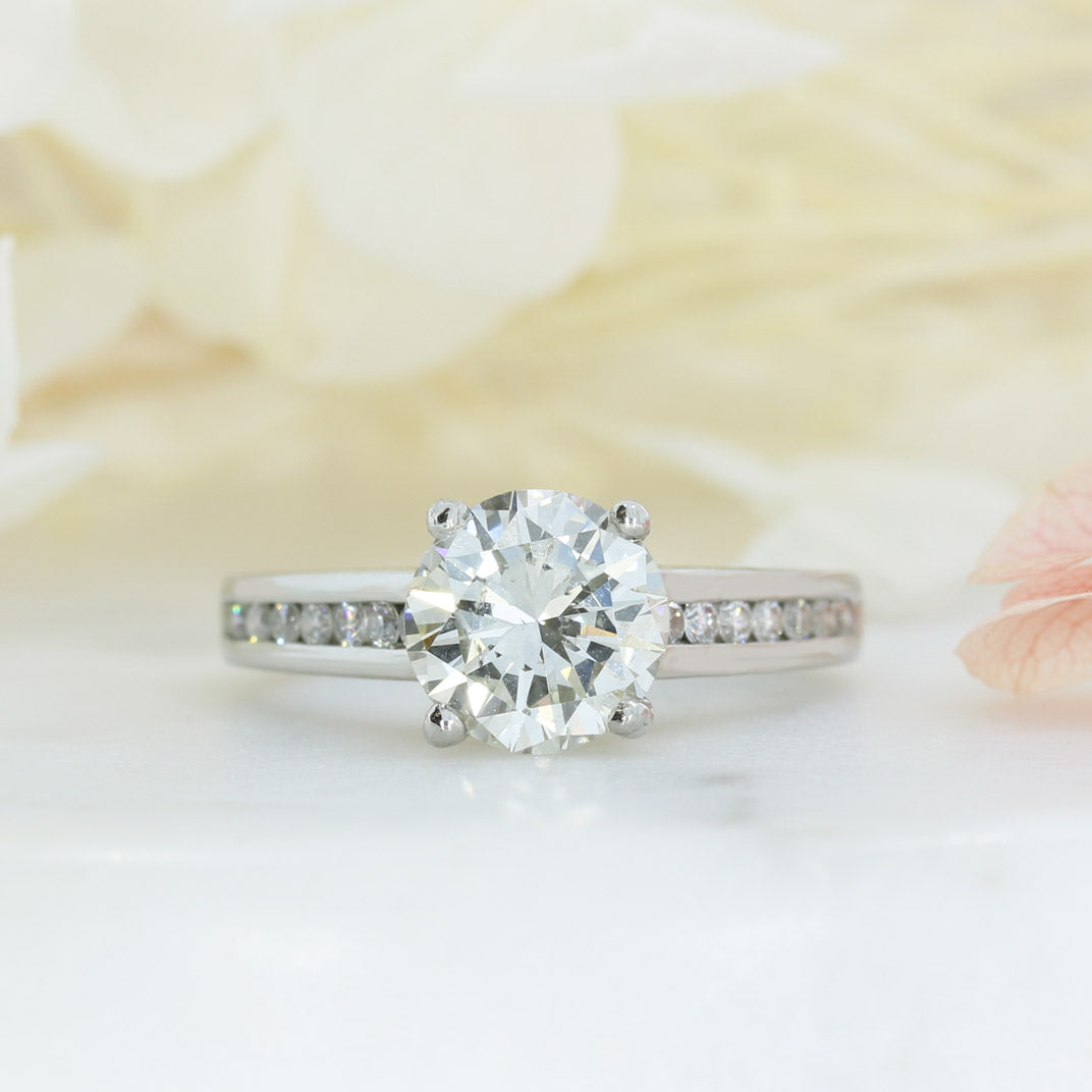 Pre Owned Platinum Natural Diamond Solitaire Ring with Channel Set Shoulders